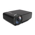 YG400 black HD LED home projector on a table with a large projected movie scene