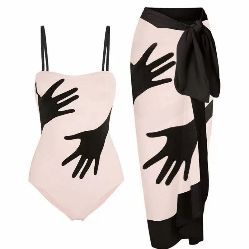Women's patterned one-piece bikini with a matching lightweight tulle skirt.