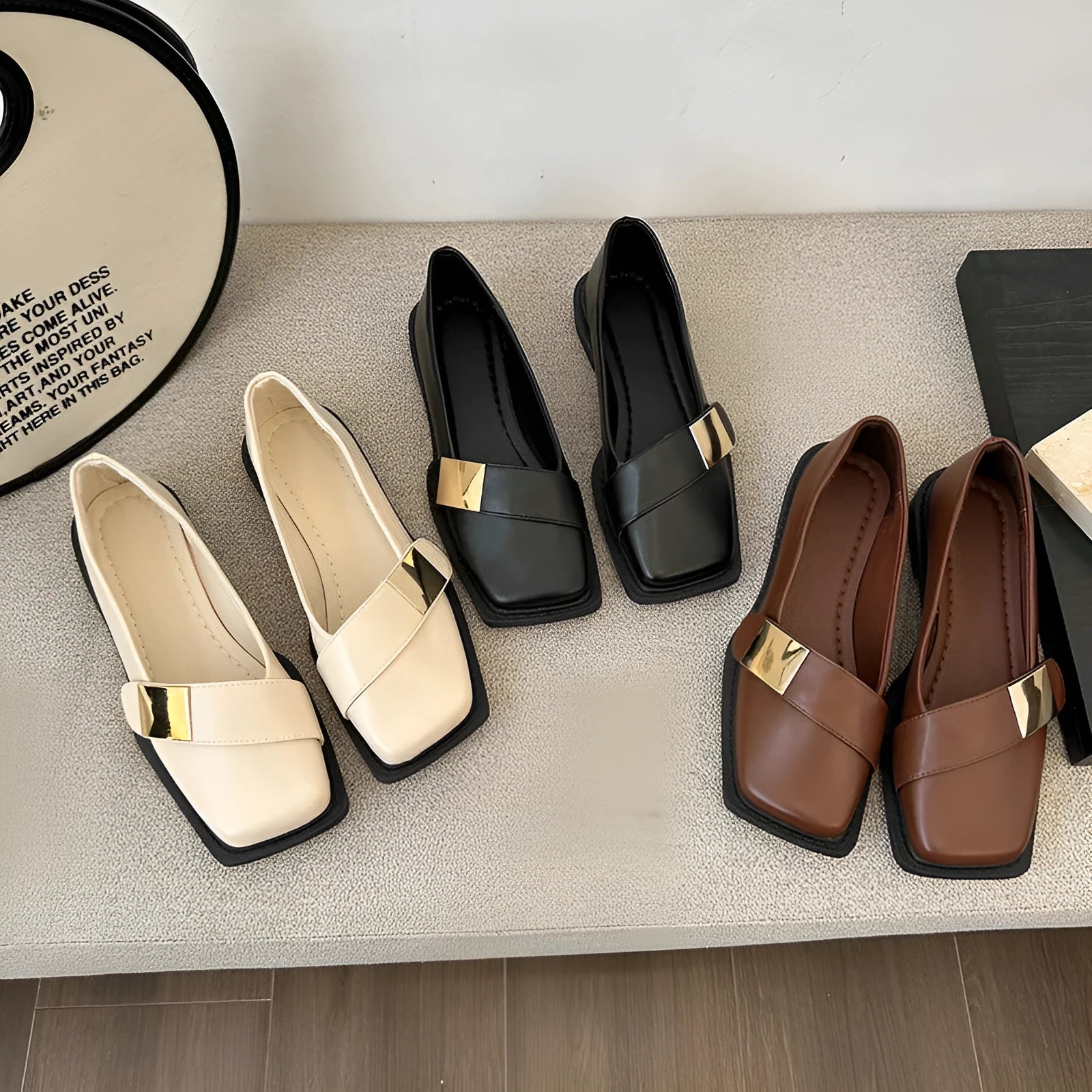 Women's beige artificial leather square toe flat-heeled slip-on ankle boots with a metal buckle.