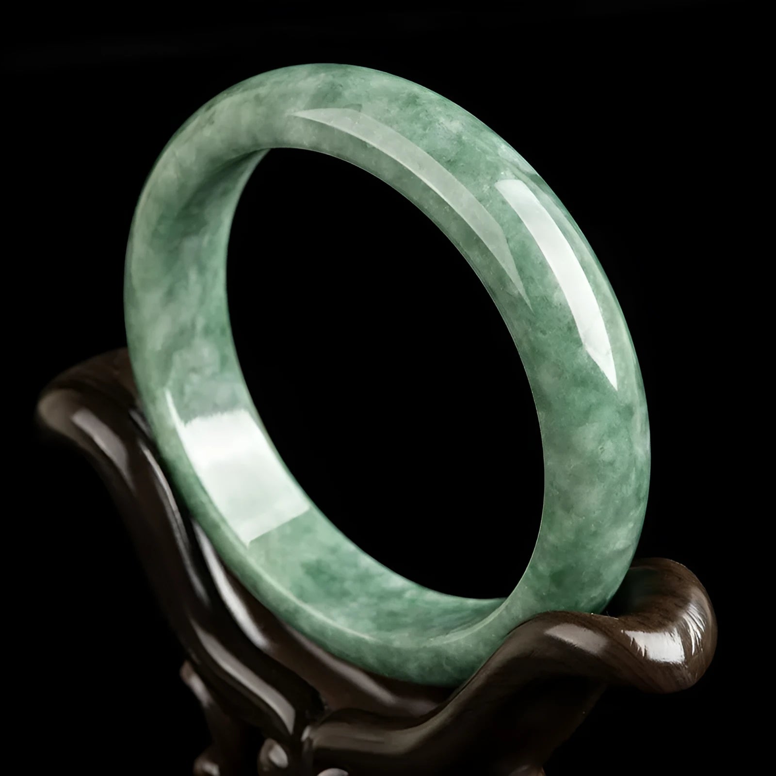 Natural emerald bean green simple solid bracelet on a gift box, showing dark pea green colour.