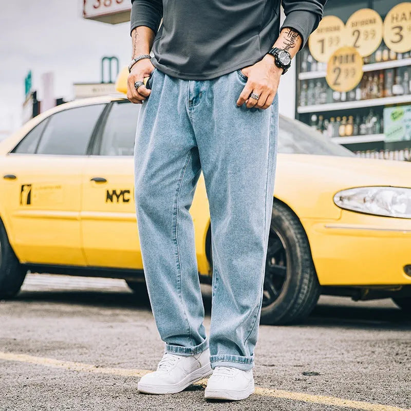 Men's loose fit straight leg casual jeans in dark blue, shown on a hanger.