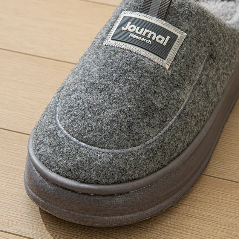 Men's brown suede slippers with thickened sole on wooden floor