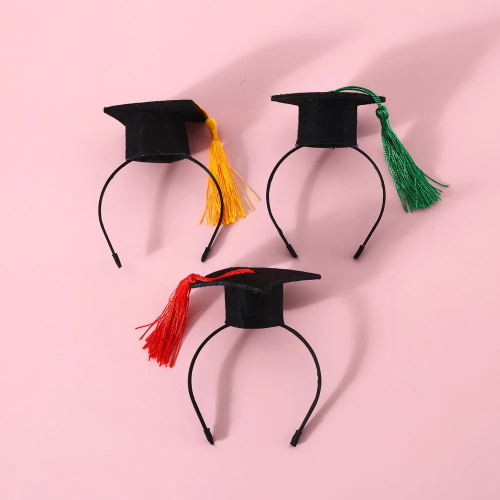 Small pet wearing a felt Doctor's Degree hair band and matching bow tie in British style.