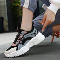 Women's white mesh casual trainers with a thick sole, round toe, and a buckle fastening detail.