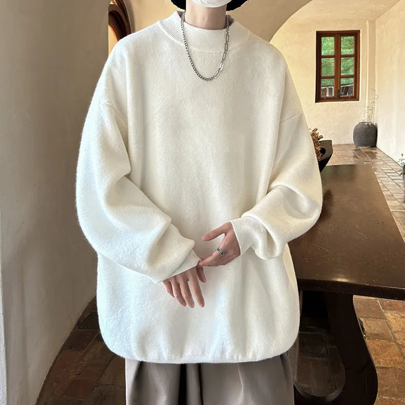 A man's solid colour round neck pullover sweater with long sleeves in a loose, casual fit.