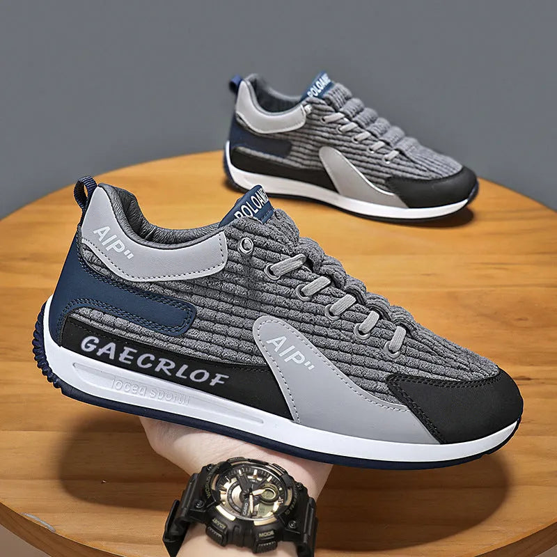 Men's grey and green mesh sports trainers with lace-up front and round toe.