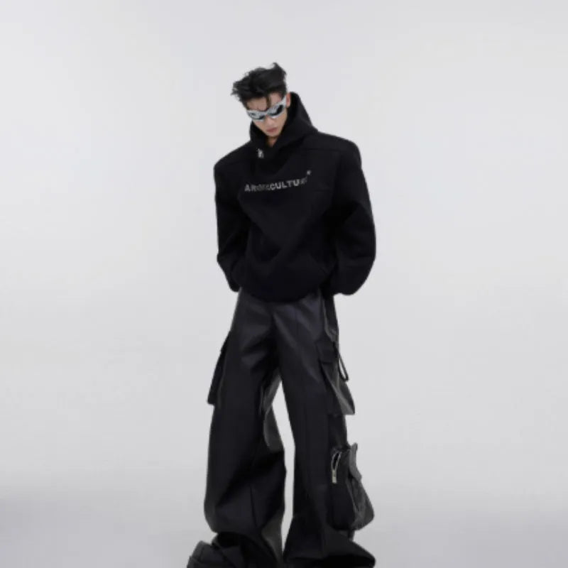 Men's loose grey hooded sweater with metallic graphic print and structured shoulder pads on a hanger.