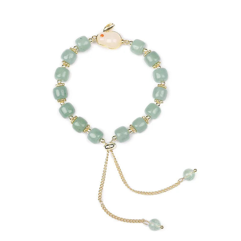 Rabbit charm bracelet with green natural stone beads and gold accents on adjustable chain