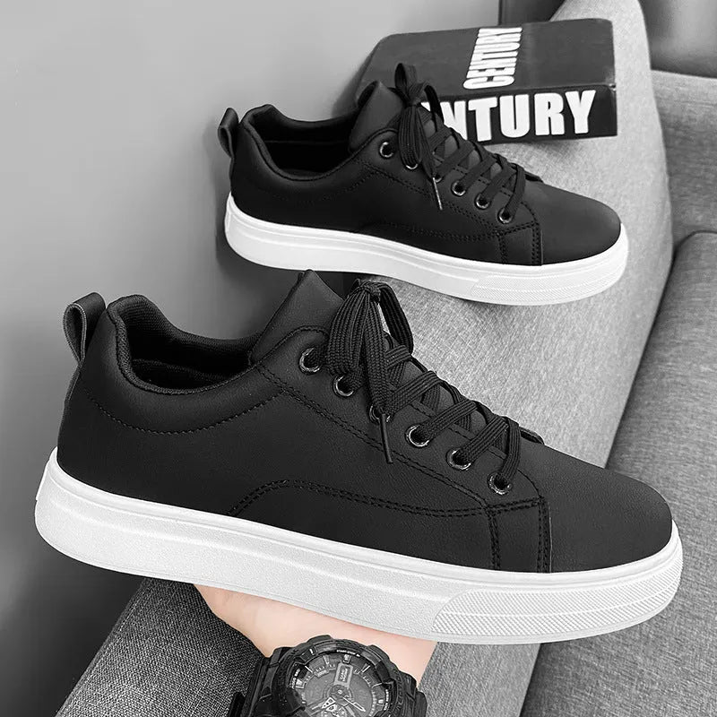 Men's low-top casual sneakers in black, white, or black with white bottom, showing round toe and flat rubber sole.