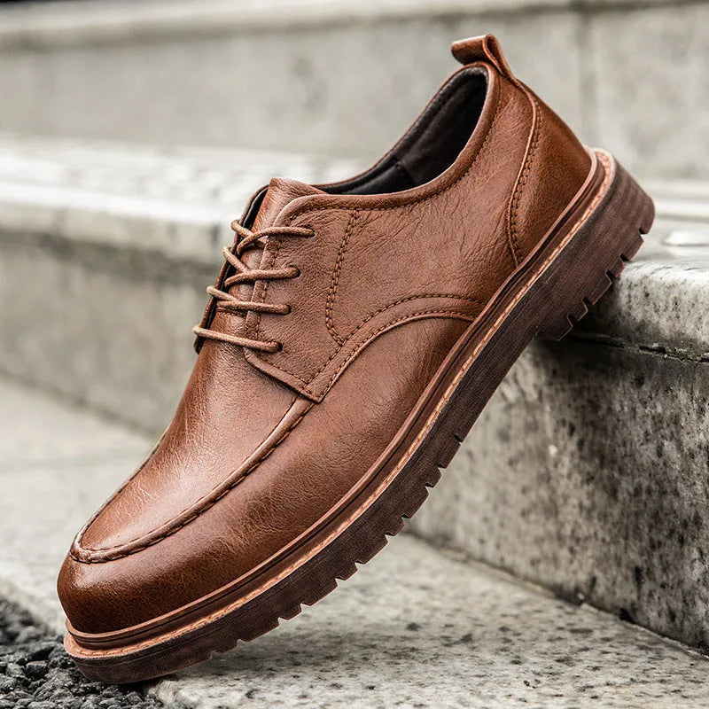 Men's black and brown low top casual leather shoes with round toe and rubber sole.
