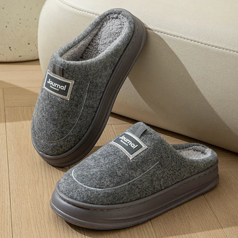 Men's brown suede slippers with thickened sole on wooden floor