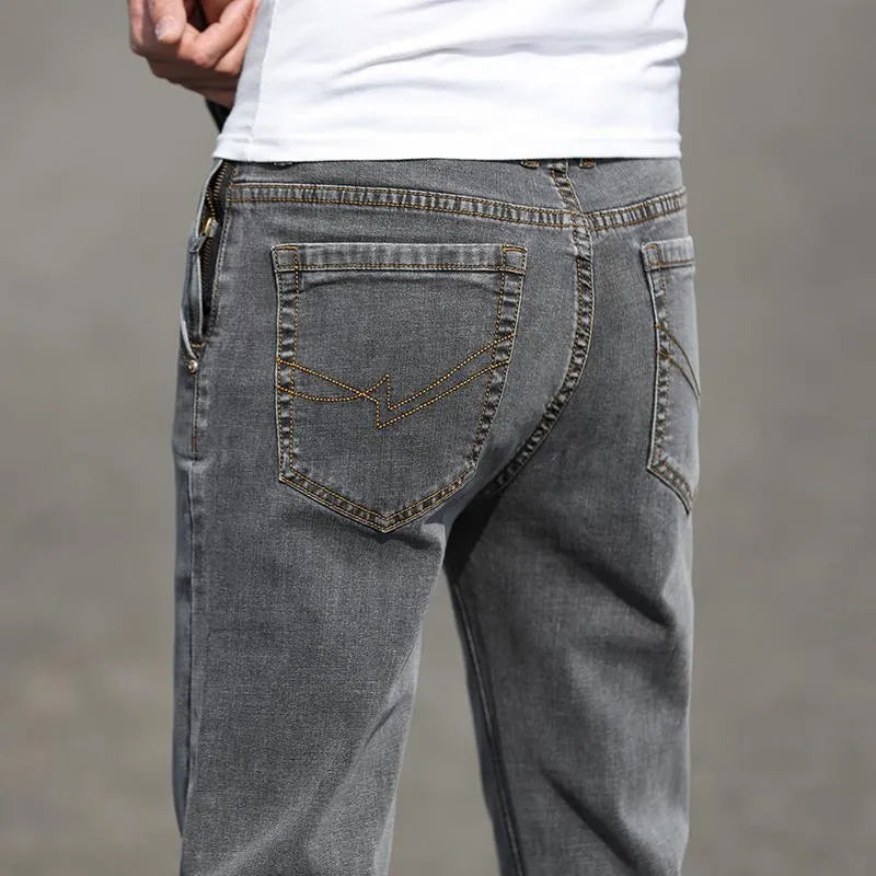 Men's straight-leg jeans in smoky grey colour with low waist design and zipper fly closure