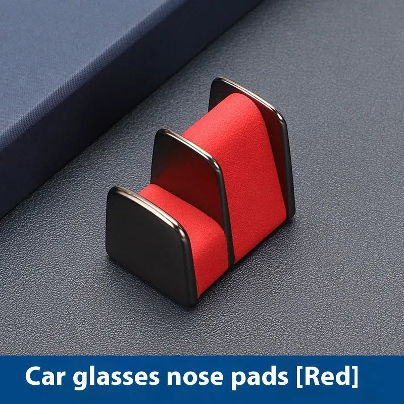 Zinc alloy and leather car dashboard clip for holding sunglasses, shown in green.