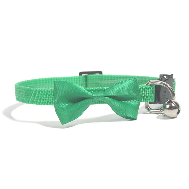 Adjustable nylon cat collar with decorative bow and bell in striped cartoon pattern, multiple colour options shown