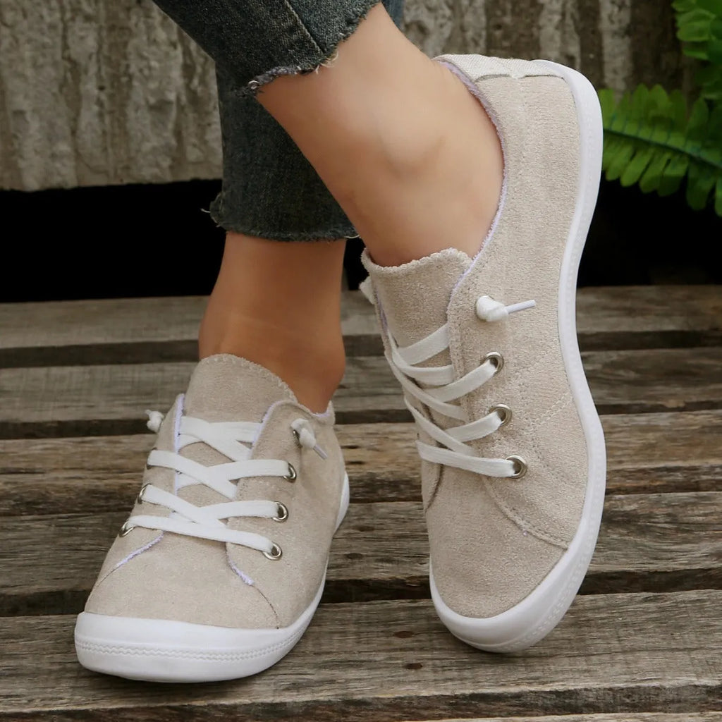 Women's low-top beige fabric casual sneakers on a white background.