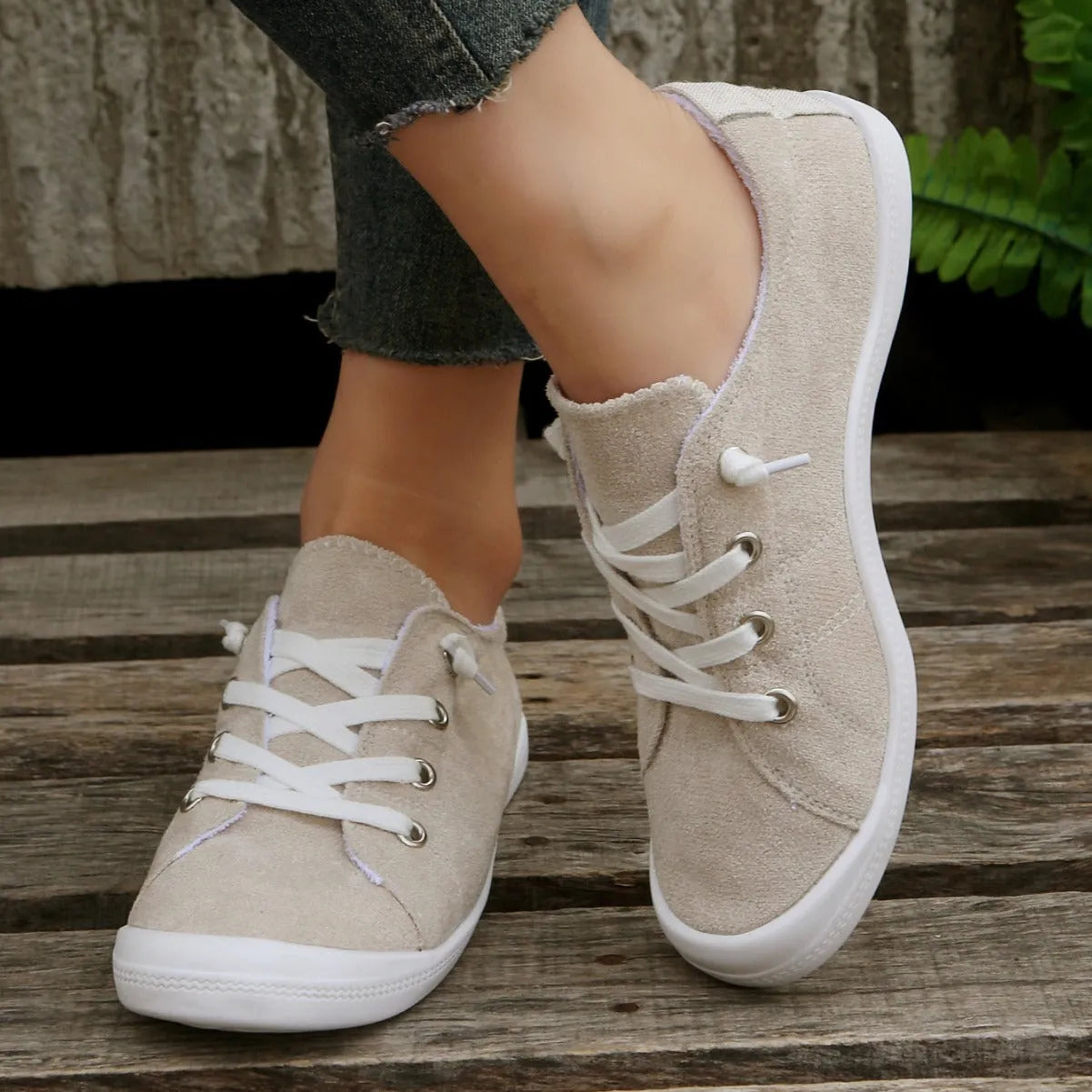Women's low-top beige fabric casual sneakers on a white background.