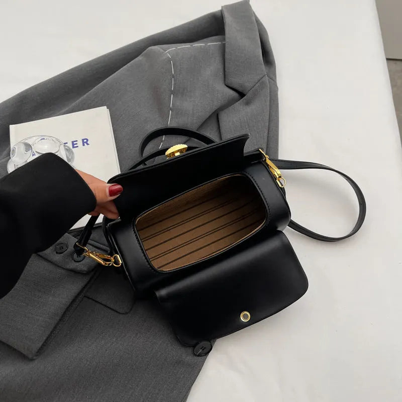 Women's personalised black PU leather messenger bag with embroidered letter 'A' on the front flap.