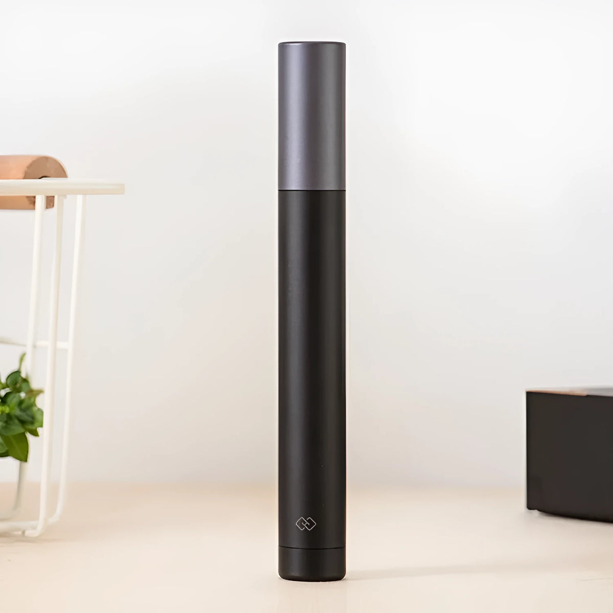 Black electric nose hair trimmer with ABS body, portable and battery-powered