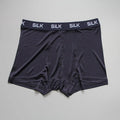 Men's loose navy blue silk shorts with a mid-waist design on a neutral background