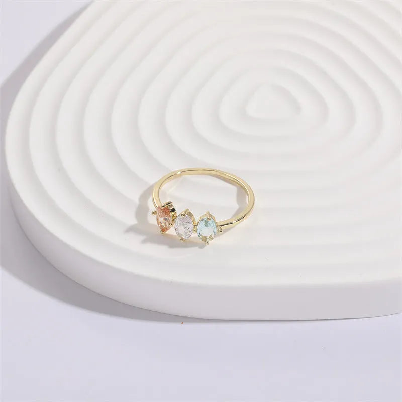 Geometric copper ring with a horse eye motif and tricolour zircon stone, electroplated in 14K Real Gold RG9066 colour.