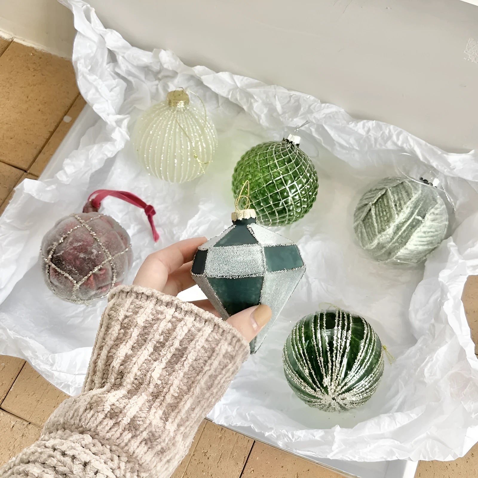 Handmade glass Christmas ball pendant 8cm in green colour hanging on tree branch