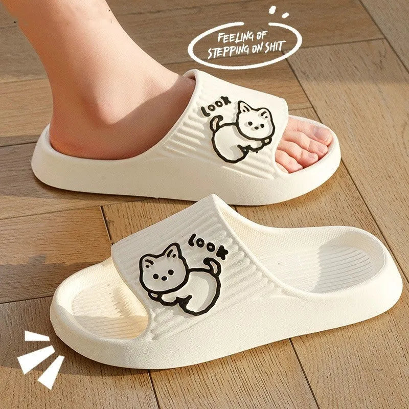 Women's green cat slippers with thick platform sole and flip-flop design on a white background.