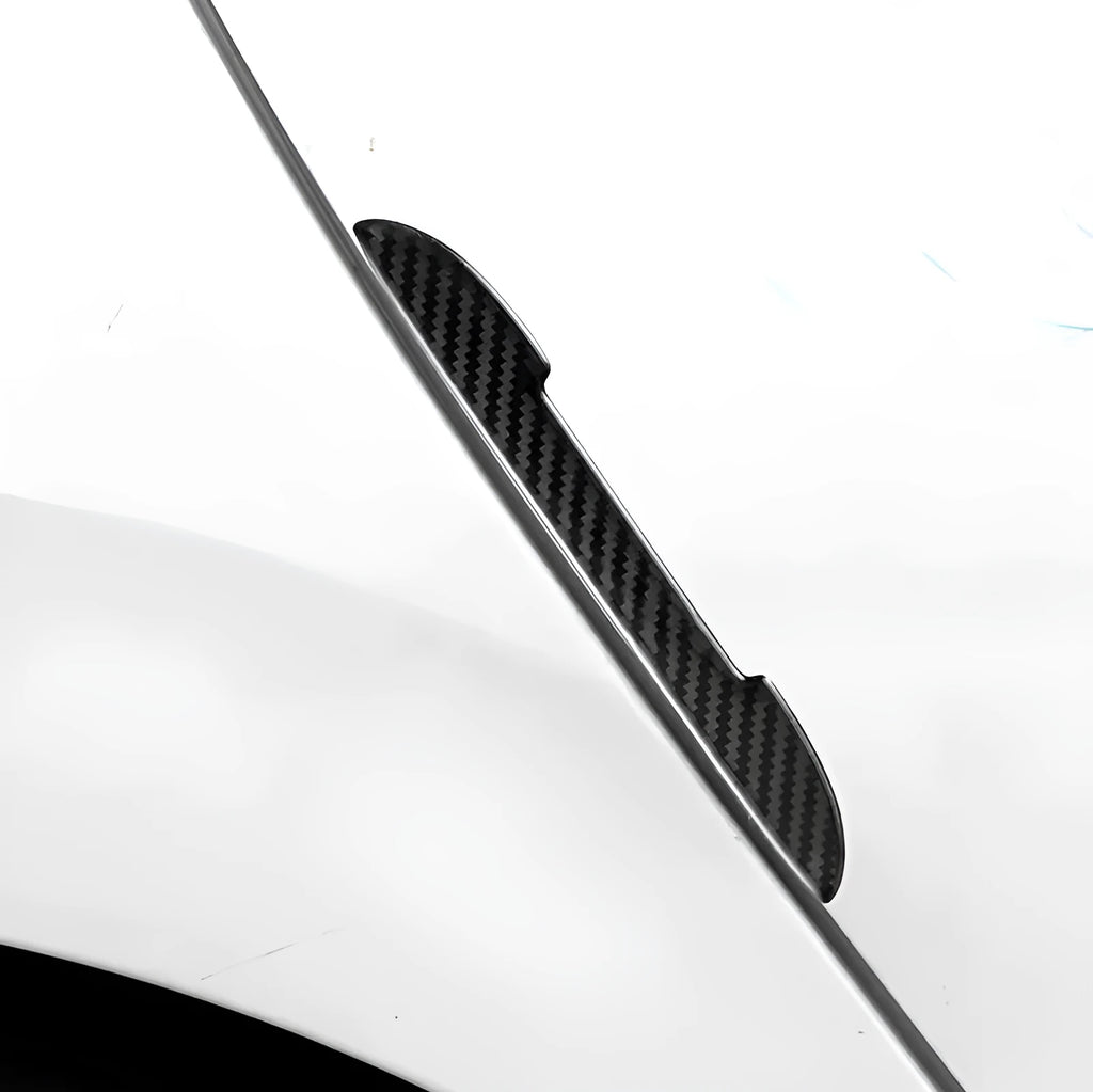 Black carbon fibre texture car door edge protector strips laid out flat.