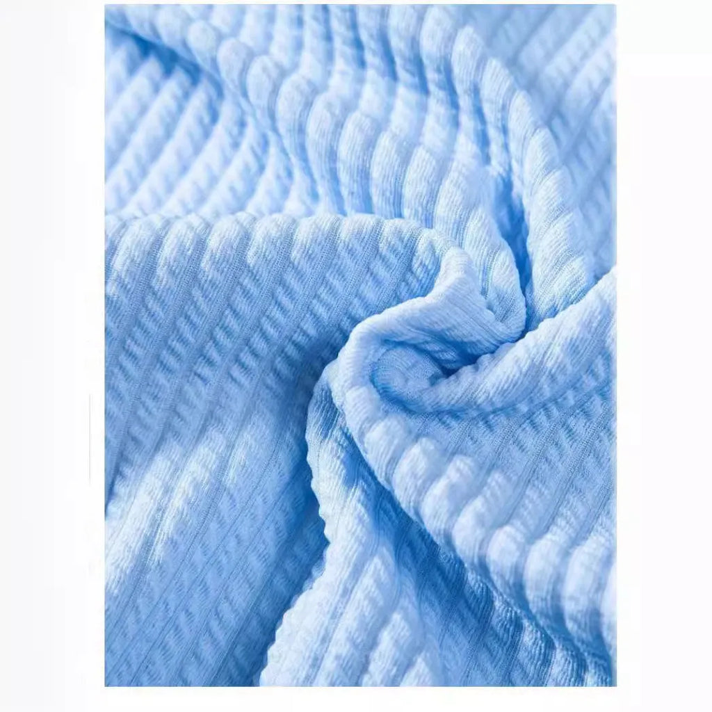 Men's loose fit short sleeve casual shirt in light blue, hanging on a plain background.