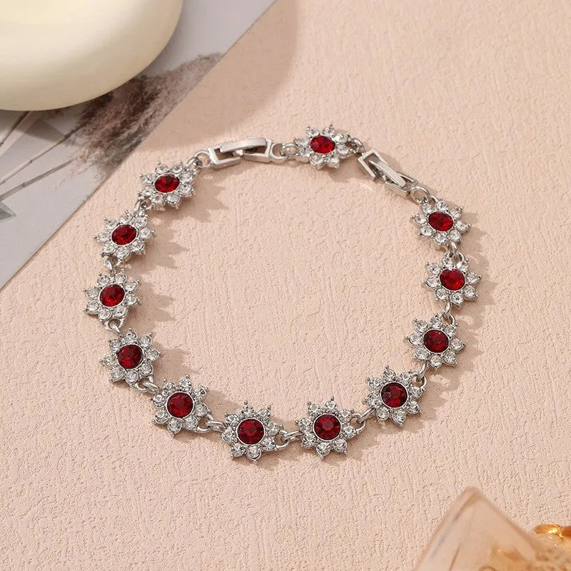 Electroplated zinc alloy floral bracelet showing colour variations including gold and silver tone options