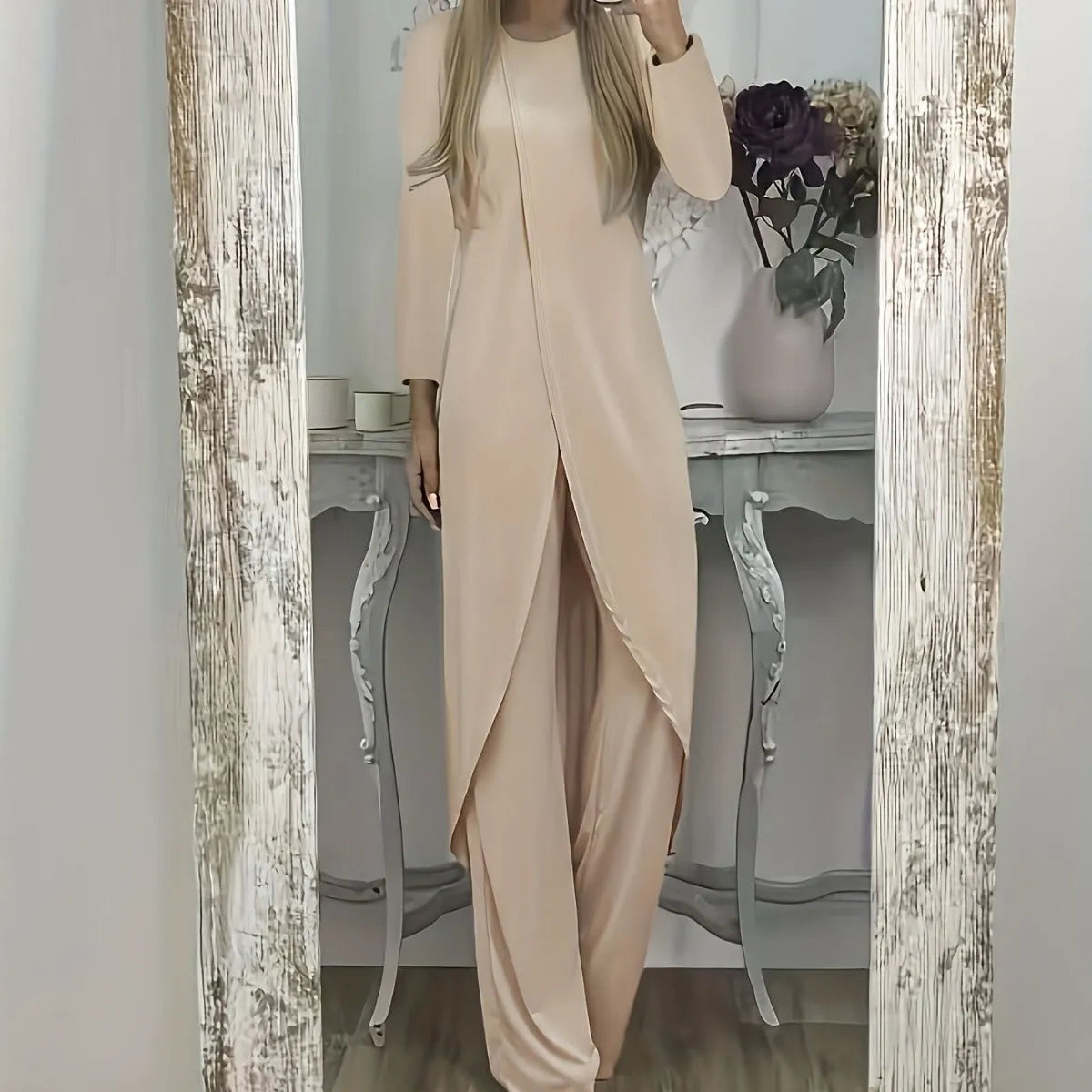 A loose-fitting black two-piece lounge set consisting of a long-sleeve round-neck top and matching trousers.