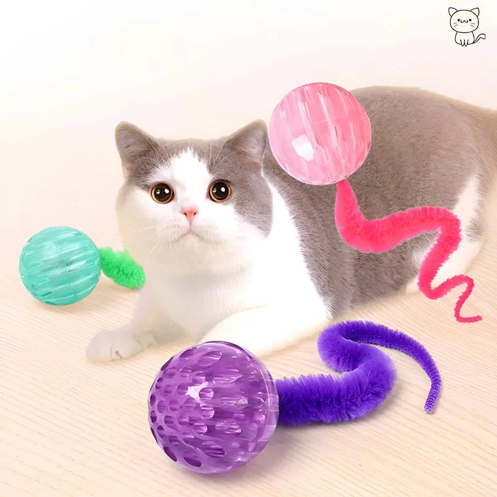 Interactive cat ball toy with elastic worm tail in green colour on wooden floor
