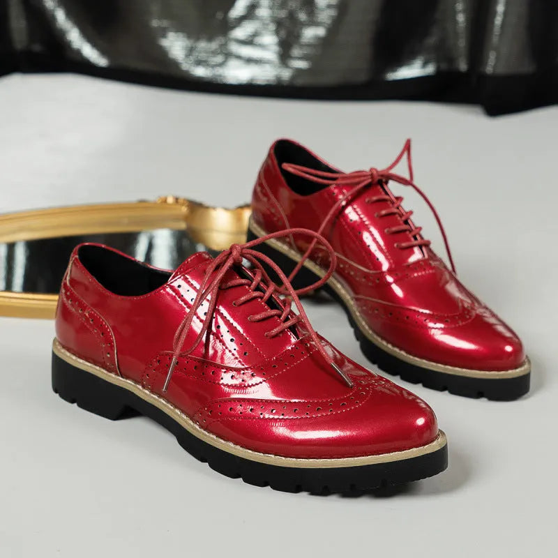 Women's black sequined lace-up loafers with a wedge heel and round toe, shown on a mid-calf.