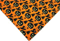 Halloween dog bandana with pumpkin and spider web patterns in black and orange colours