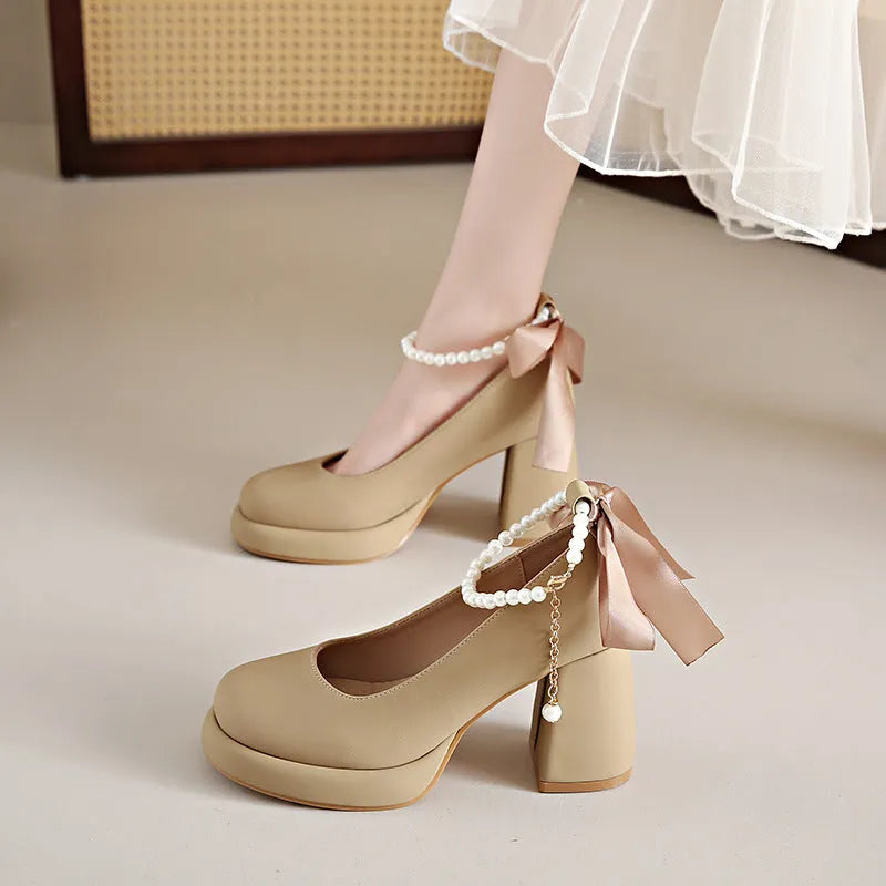 Beige women's Mary Jane shoes with a chunky heel, round toe, and an ankle-strap buckle.