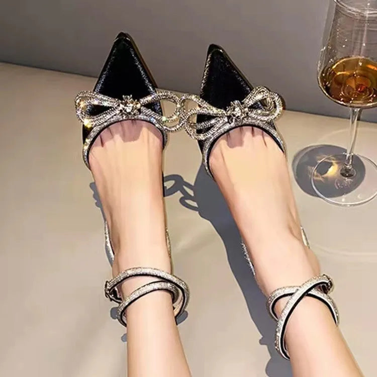 Women's black stiletto heel sandals with a silk back bandage and buckle closure.