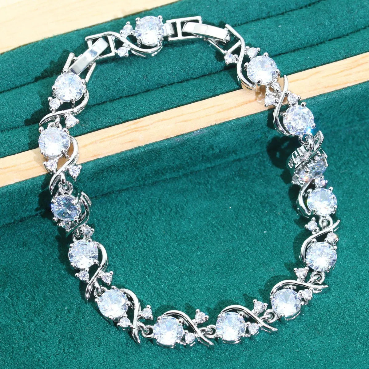 Four-piece bridal jewellery set showing zircon necklace, bracelet, earrings, and ring in coordinating design
