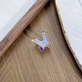 Adjustable copper insect ring with dripping oil finish in one of three colours on a hand.
