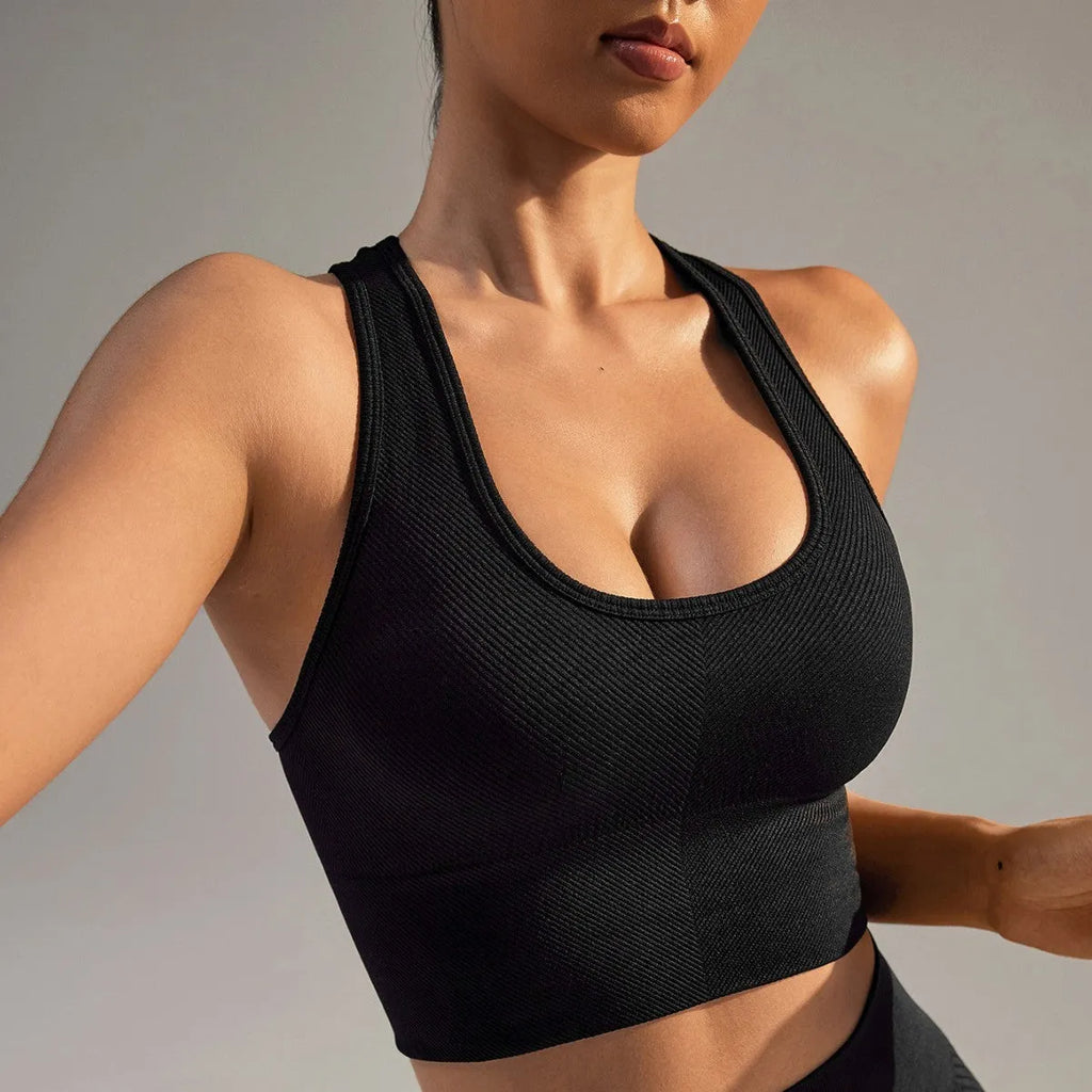 Black women's sports bra with cross back design and full cup support for athletic wear.
