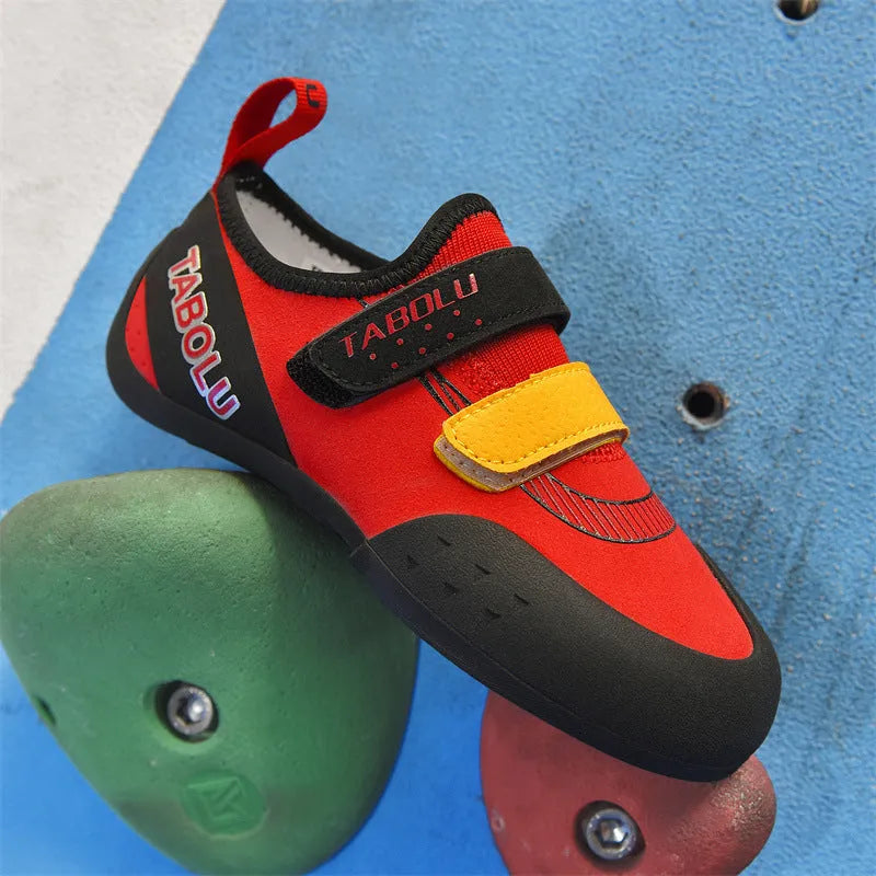Beginner rock climbing shoes with Velcro straps and non-slip rubber soles in black/red colour