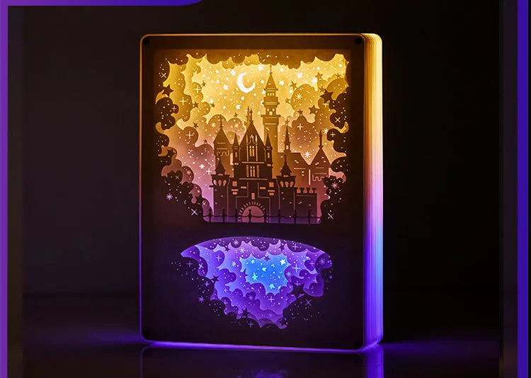 ABS frame bedside night light with 3D paper carving design and remote control on a table.