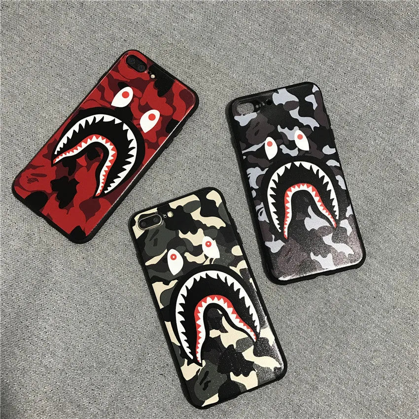 Frosted silicone phone case with shark mouth design in red, green, gray, and pink colours