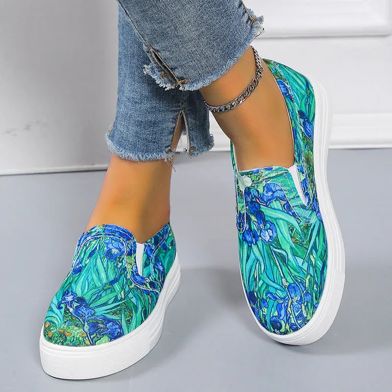 Women's blue low-top canvas sneaker with flat rubber sole on a plain background.