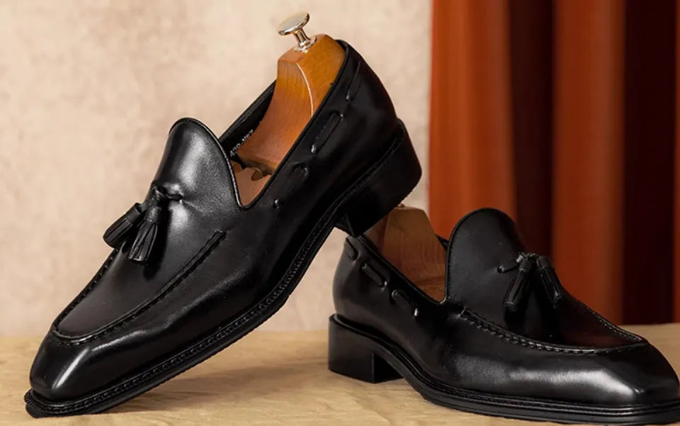 Men's genuine leather slip-on loafers with fringed detailing in black or brown