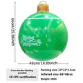 Large red inflatable Christmas ball with gold snowflake design hanging in garden with LED lights illuminated