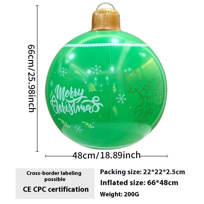Large red inflatable Christmas ball with gold snowflake design hanging in garden with LED lights illuminated
