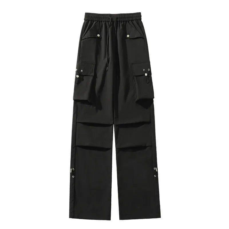 Women's plus size straight-leg waterproof trousers in black on a hanger, showing drawstring waist detail.