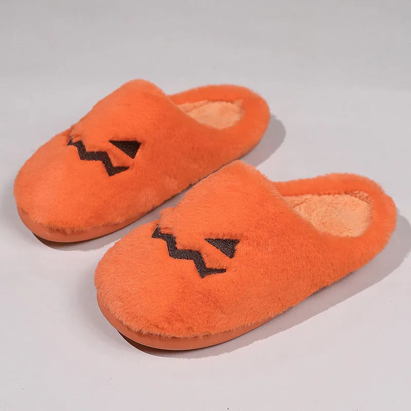 Orange plush Halloween pumpkin slippers with coral velvet upper and flat PVC sole.