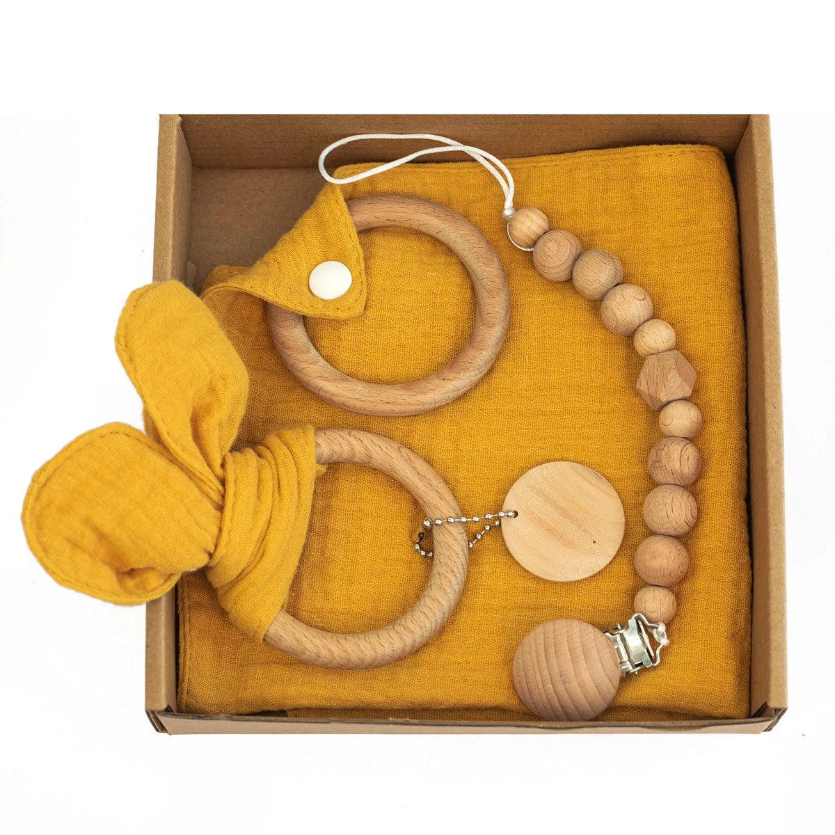 Baby teething toy gift set with bamboo blend gauze blanket, wooden beech bell, teether, brush, and milestone marker.