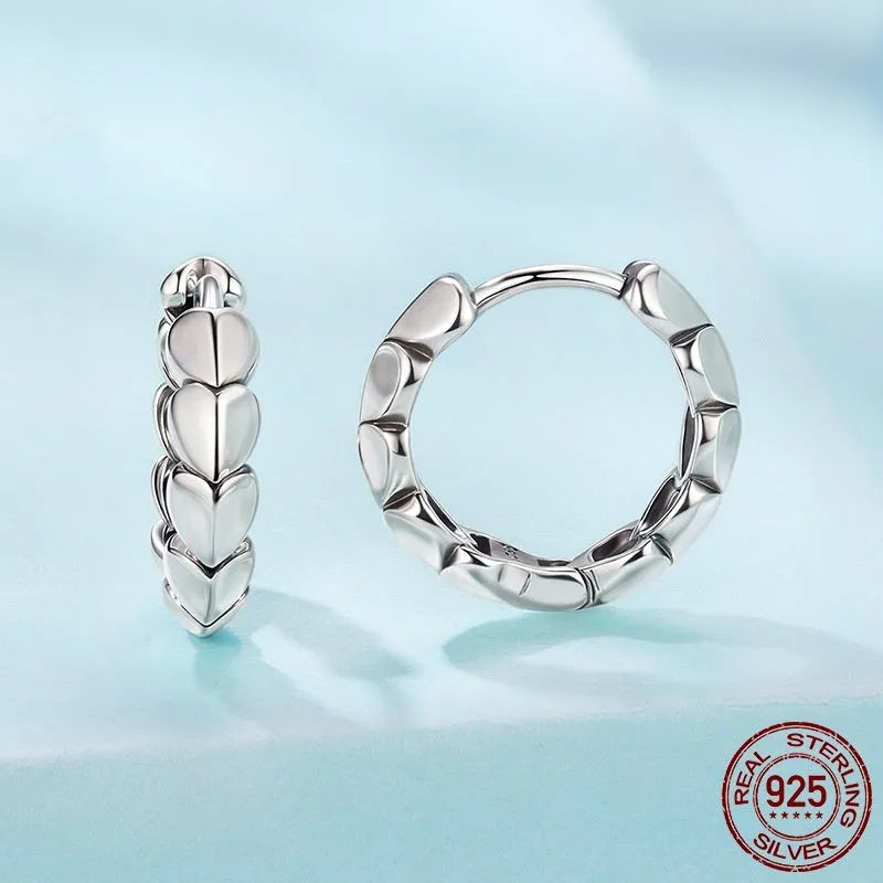 S925 sterling silver loving heart splicing ear clip with polished finish on white background