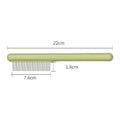 Stainless steel cat grooming comb with rounded teeth and ergonomic handle in green colour